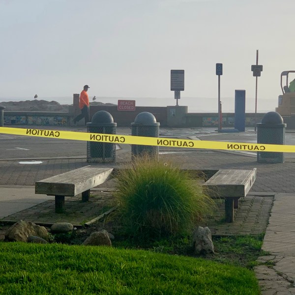 Caution tape closes Capitola Beach due to high surf on Monday, Dec. 23, 2024, in Capitola, Calif. (AP Photo/Pamela Hassell)