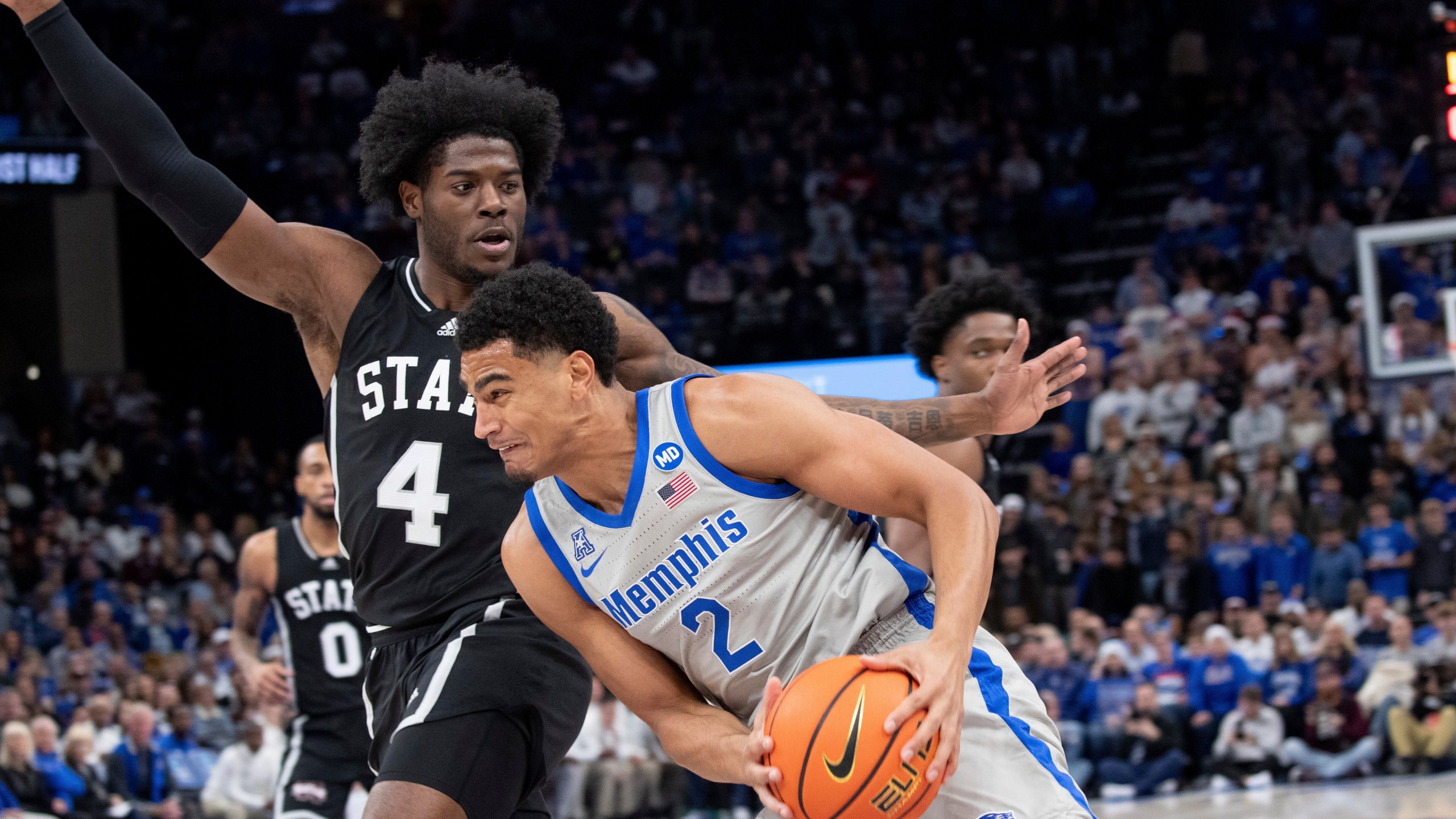 Mississippi State forward Cameron Matthews (4) defends Memphis forward Nicholas Jourdain (2) during the first half of an NCAA college basketball game Saturday, Dec. 21, 2024, in Memphis, Tenn. (AP Photo/Nikki Boertman)