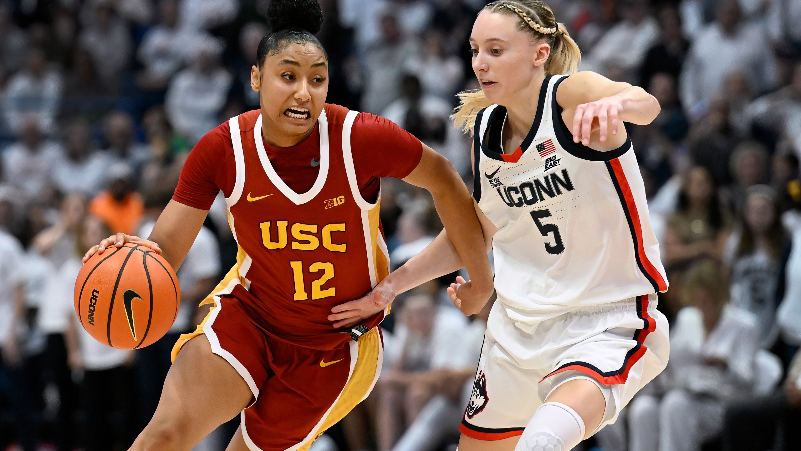 Southern California guard JuJu Watkins (12) is guarded by UConn guard Paige Bueckers (5) in the second half of an NCAA college basketball game, Saturday, Dec. 21, 2024, in Hartford, Conn. (AP Photo/Jessica Hill)