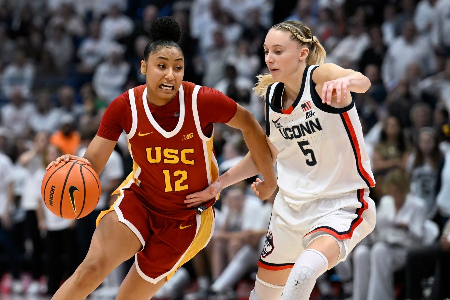 Southern California guard JuJu Watkins (12) is guarded by UConn guard Paige Bueckers (5) in the second half of an NCAA college basketball game, Saturday, Dec. 21, 2024, in Hartford, Conn. (AP Photo/Jessica Hill)