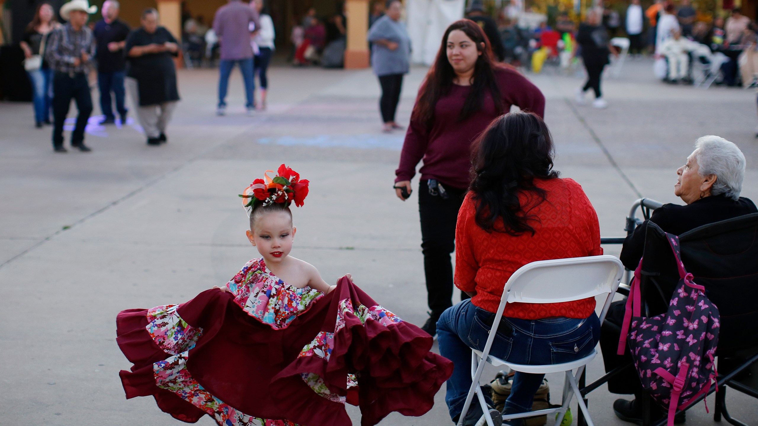 FILE - People gather in Guadalupe, Ariz., during the celebration of the town's 45th year since it was incorporated, on Feb. 8, 2020. (AP Photo/Dario Lopez-MIlls, File)