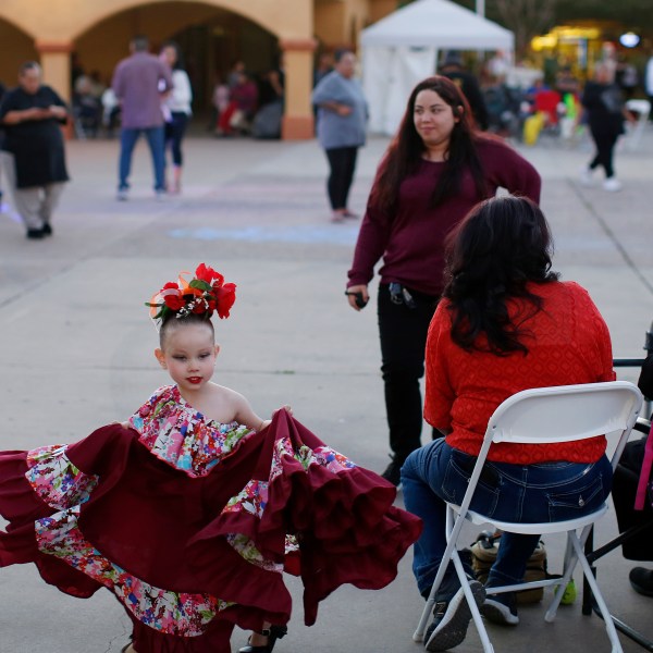 FILE - People gather in Guadalupe, Ariz., during the celebration of the town's 45th year since it was incorporated, on Feb. 8, 2020. (AP Photo/Dario Lopez-MIlls, File)