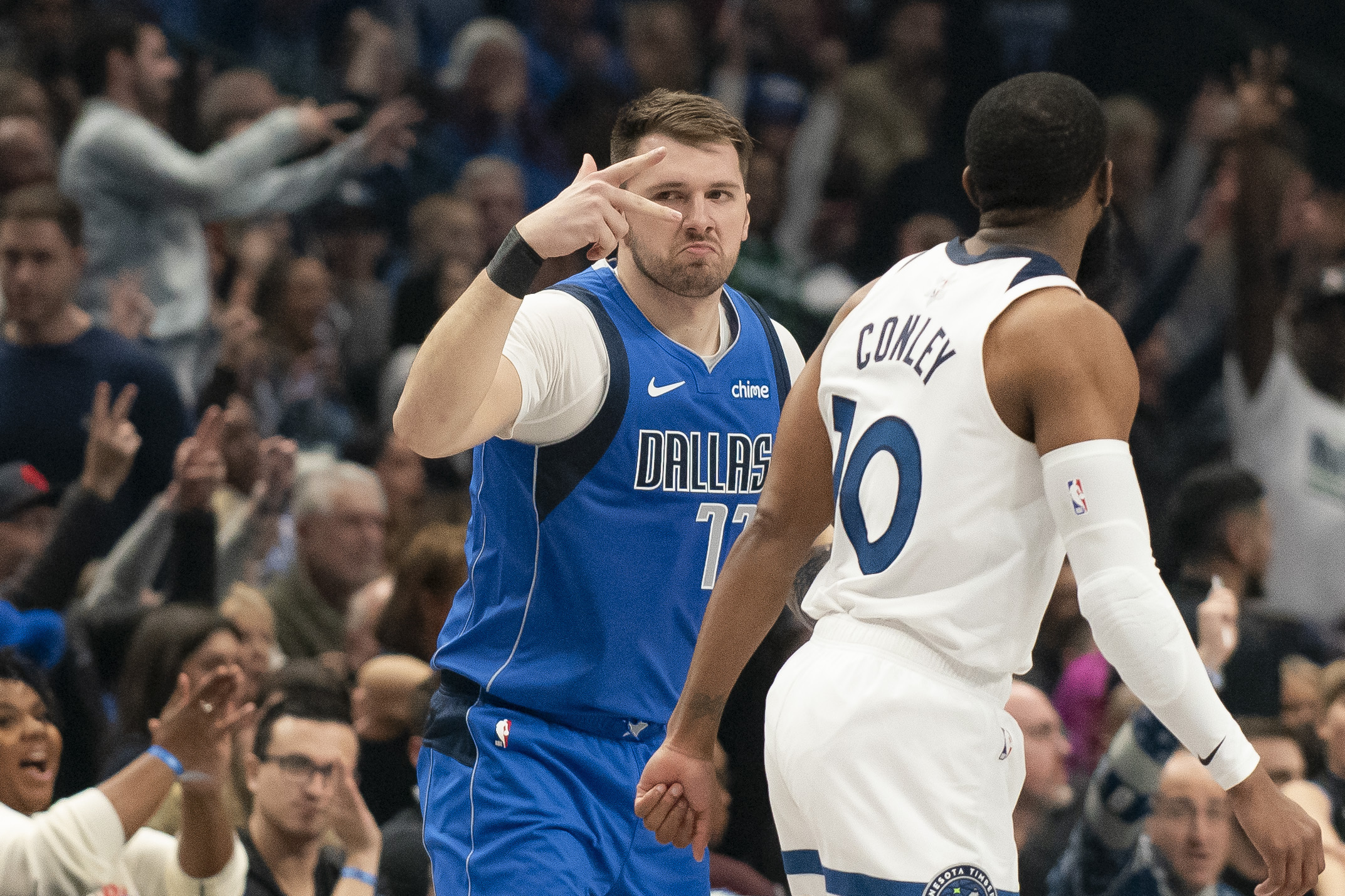 Dallas Mavericks guard Luka Doncic (77) celebrates after hitting a three-pointer over Minnesota Timberwolves guard Mike Conley (10) in the first half of an NBA basketball game on Wednesday, Dec. 25, 2024, in Dallas. (AP Photo/Emil T. Lippe)