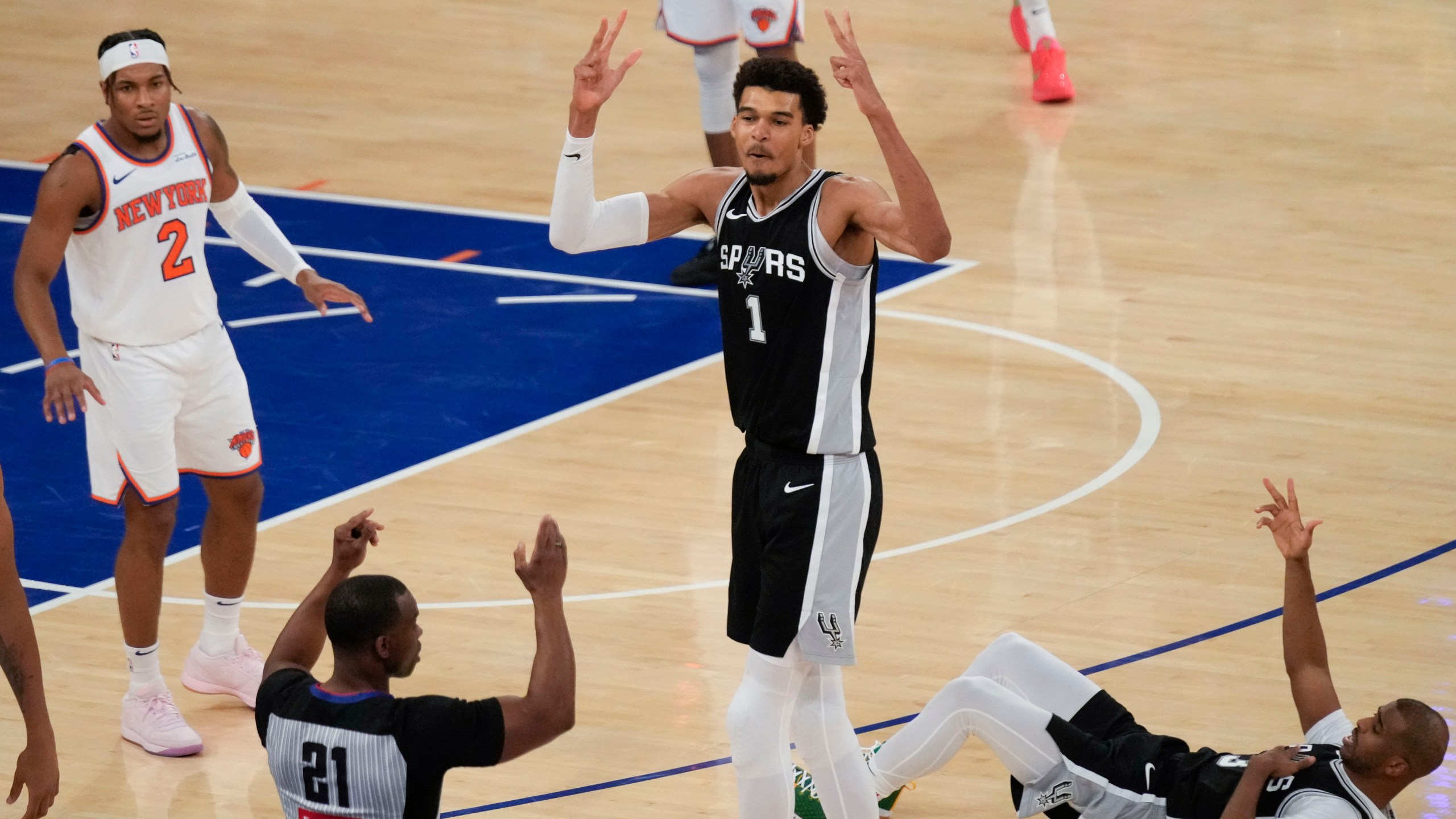 San Antonio Spurs' Victor Wembanyama (1), center, reacts as he sinks a three point basket during the second half of an NBA basketball game against the New York Knicks, Wednesday, Dec. 25, 2024, in New York. The basket was not counted after an officials review. The Knicks defeated the Spurs 117-114. (AP Photo/Seth Wenig)