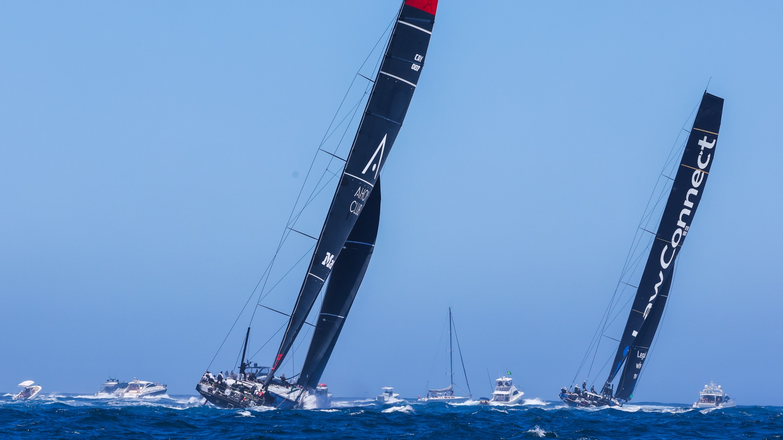 Master Lock Comanche, left, and LawConnect sail out of the heads following the start of the Sydney to Hobart yacht race in Sydney, Thursday, Dec. 26, 2024. (Mark Evans/AAP Image via AP).