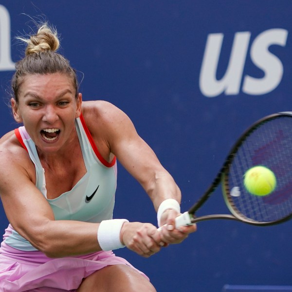 FILE - Simona Halep, of Romania, returns a shot to Daria Snigur, of Ukraine, during the first round of the U.S. Open tennis tournament, Aug. 29, 2022, in New York. (AP Photo/Seth Wenig, File)