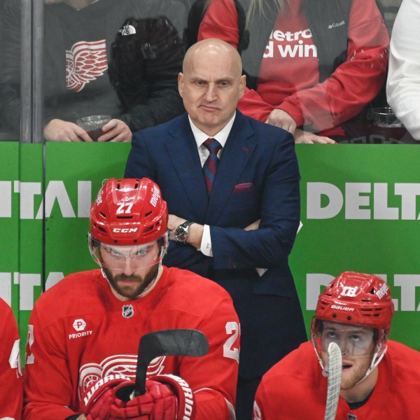 Detroit Red Wings head coach Derek Lalonde, standing, watches during the first period of an NHL hockey game against the St. Louis Blues, Monday, Dec. 23, 2024, in Detroit. (AP Photo/Jose Juarez)