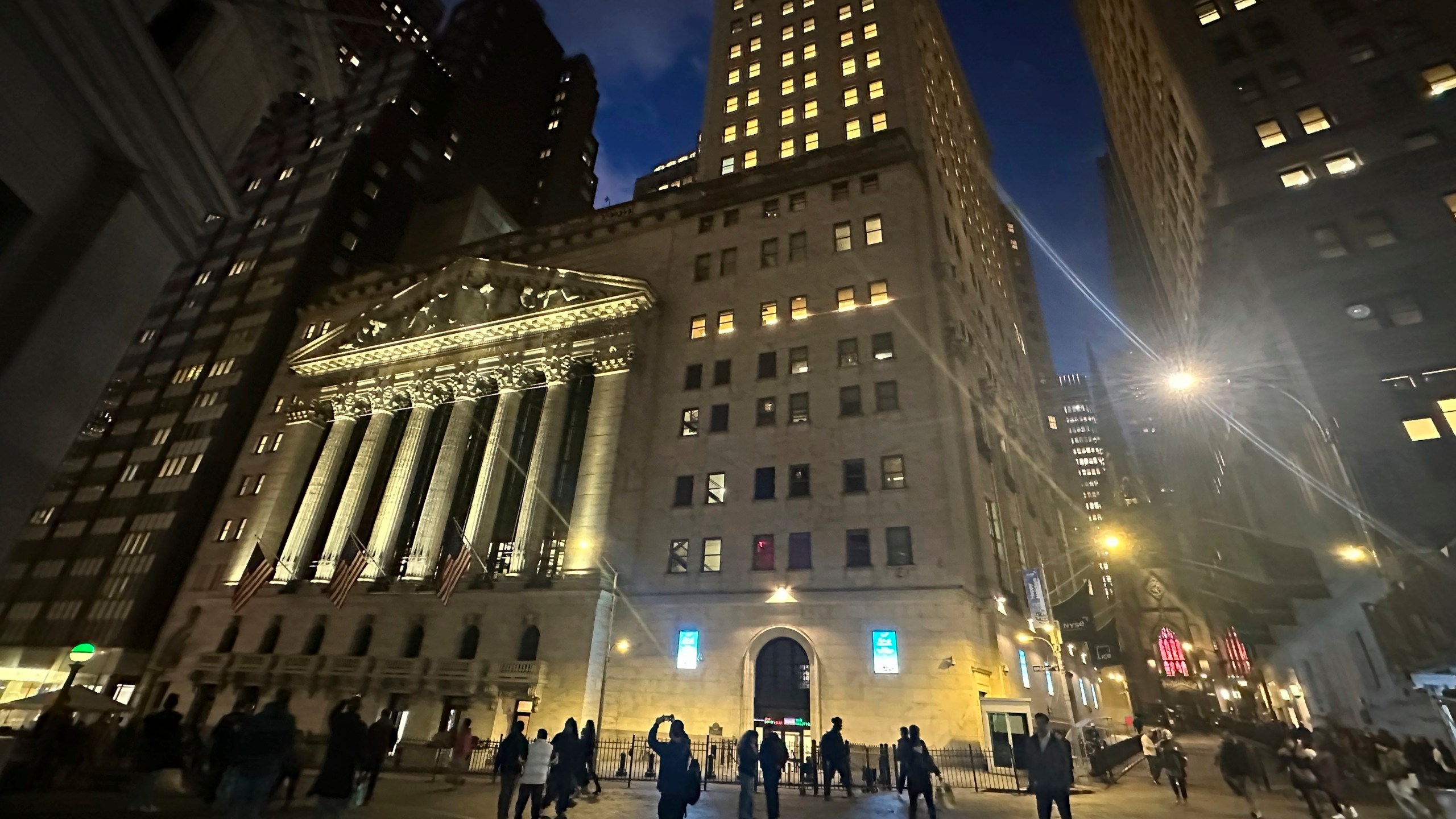 FILE - People walk past the New York Stock Exchange on Nov. 26 2024. (AP Photo/Peter Morgan, File)