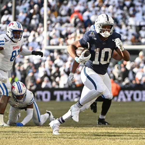 Penn State running back Nicholas Singleton (10) runs past SMU safety Brandon Crossley during the second half in the first round of the College Football Playoff, Saturday, Dec. 21, 2024, in State College, Pa. (AP Photo/Barry Reeger)