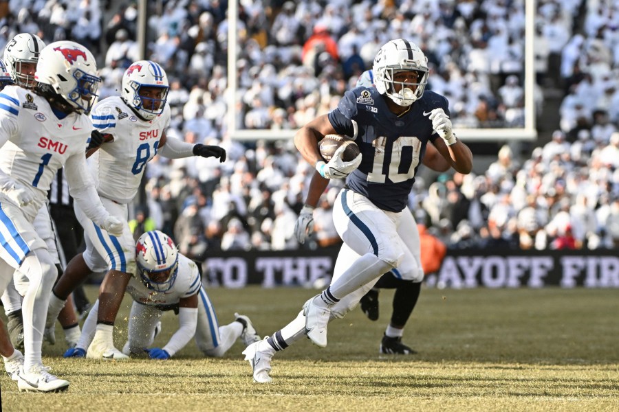 Penn State running back Nicholas Singleton (10) runs past SMU safety Brandon Crossley during the second half in the first round of the College Football Playoff, Saturday, Dec. 21, 2024, in State College, Pa. (AP Photo/Barry Reeger)