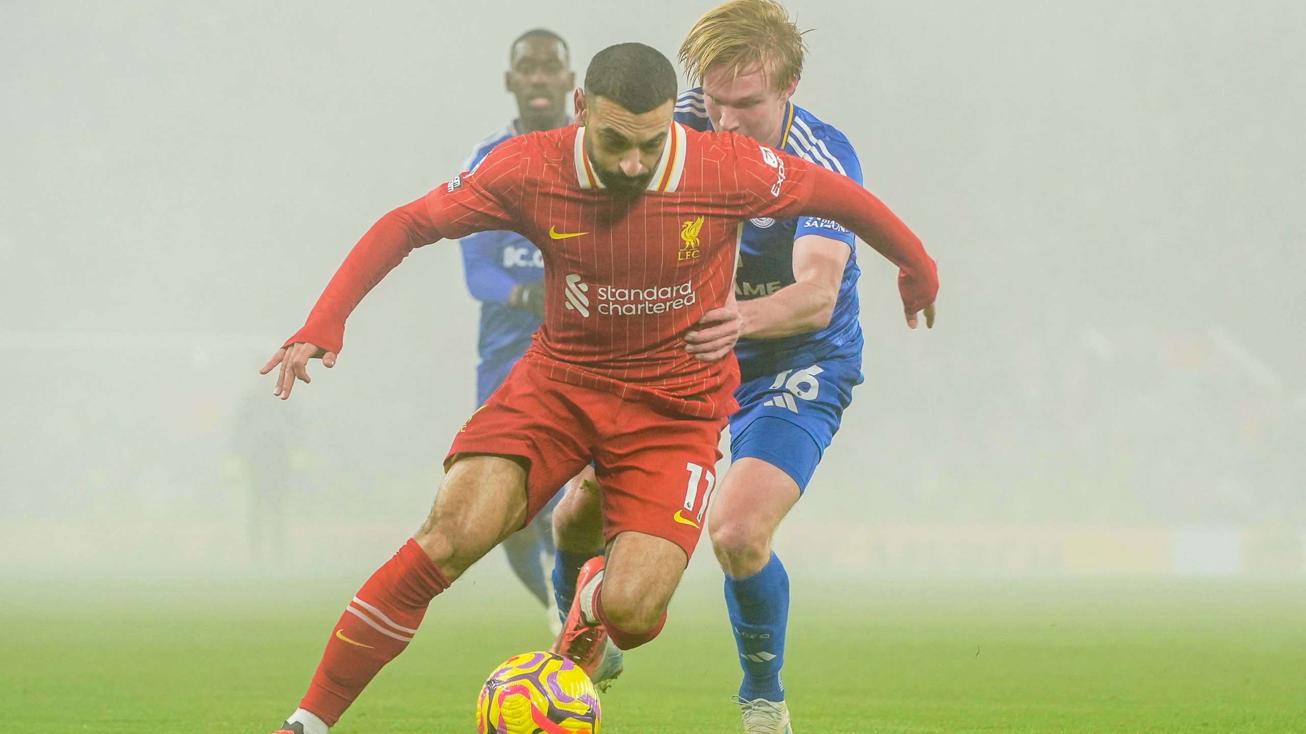 Liverpool's Mohamed Salah, front, controls a ball chased by Leicester's Victor Kristiansen during a English Premier League soccer match at the Anfield stadium in Liverpool, Thursday, Dec. 26, 2024. (AP Photo/Ian Hodgson)