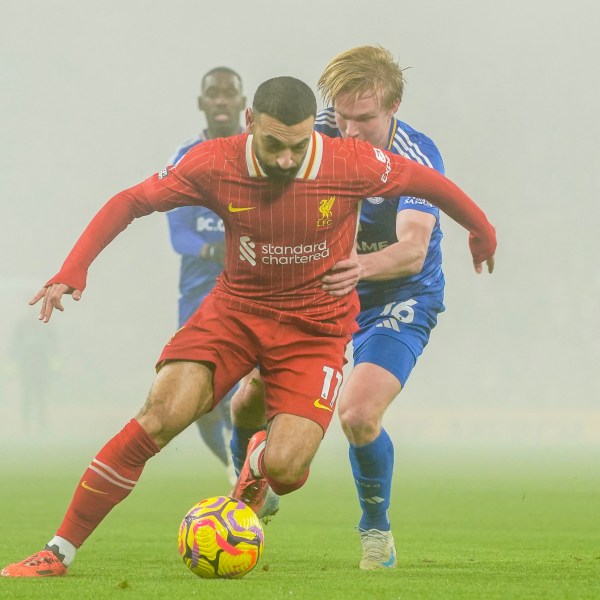 Liverpool's Mohamed Salah, front, controls a ball chased by Leicester's Victor Kristiansen during a English Premier League soccer match at the Anfield stadium in Liverpool, Thursday, Dec. 26, 2024. (AP Photo/Ian Hodgson)