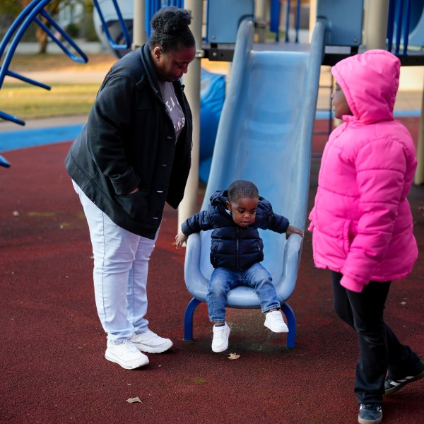 Anika Chillis spends time with her children, Makhi 2, and Myla 9, at a playground Monday, Dec. 2, 2024, in Memphis, Tenn. (AP Photo/George Walker IV)