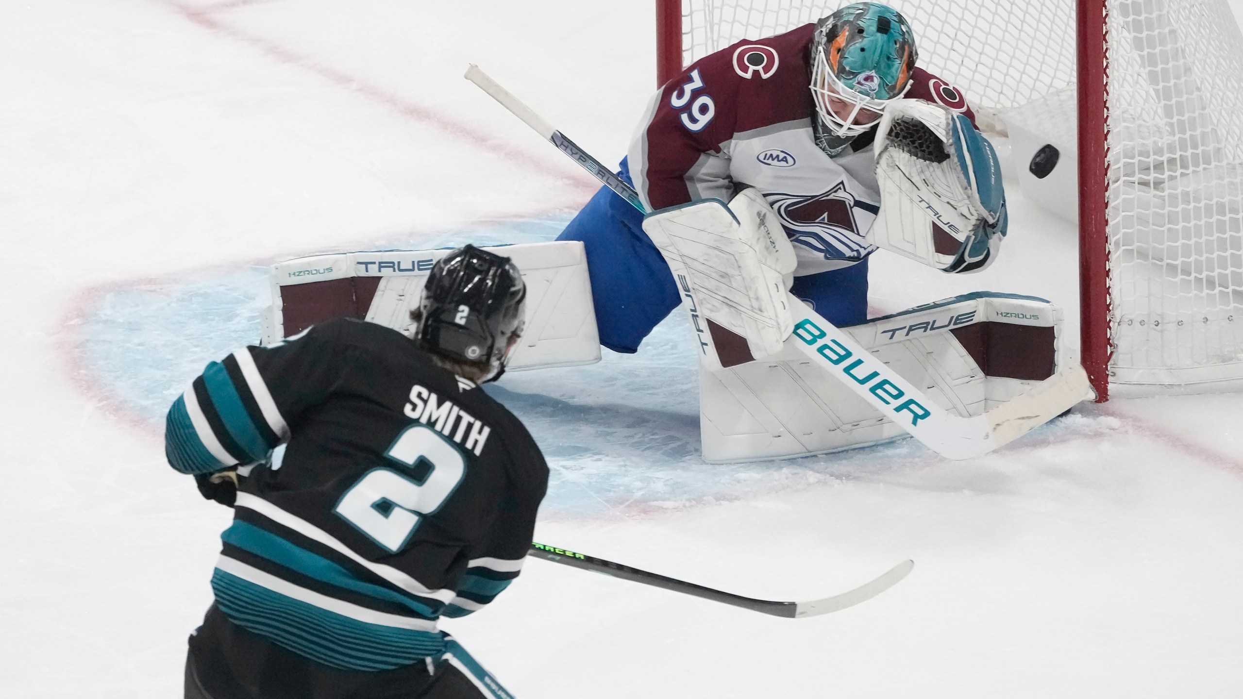 Colorado Avalanche goaltender Mackenzie Blackwood (39) defends against a shot by San Jose Sharks center Will Smith (2) during the third period of an NHL hockey game in San Jose, Calif., Thursday, Dec. 19, 2024. (AP Photo/Jeff Chiu)