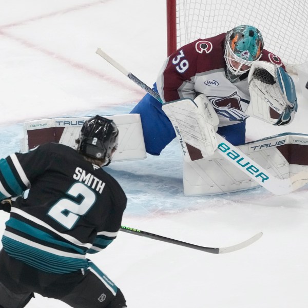 Colorado Avalanche goaltender Mackenzie Blackwood (39) defends against a shot by San Jose Sharks center Will Smith (2) during the third period of an NHL hockey game in San Jose, Calif., Thursday, Dec. 19, 2024. (AP Photo/Jeff Chiu)