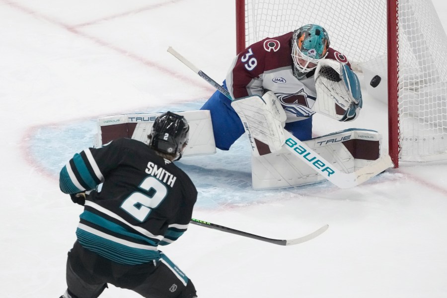 Colorado Avalanche goaltender Mackenzie Blackwood (39) defends against a shot by San Jose Sharks center Will Smith (2) during the third period of an NHL hockey game in San Jose, Calif., Thursday, Dec. 19, 2024. (AP Photo/Jeff Chiu)