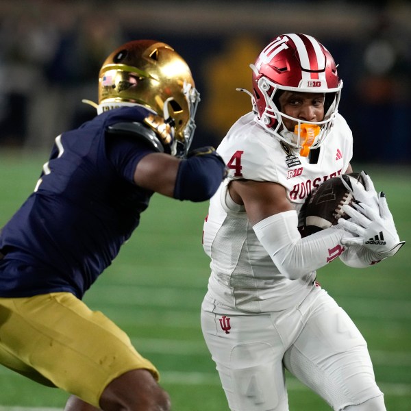 Indiana wide receiver Myles Price (4) protects the ball from Notre Dame safety Jordan Clark (1) during the first half in the first round of the College Football Playoff, Friday, Dec. 20, 2024, in South Bend, Ind. (AP Photo/Darron Cummings)