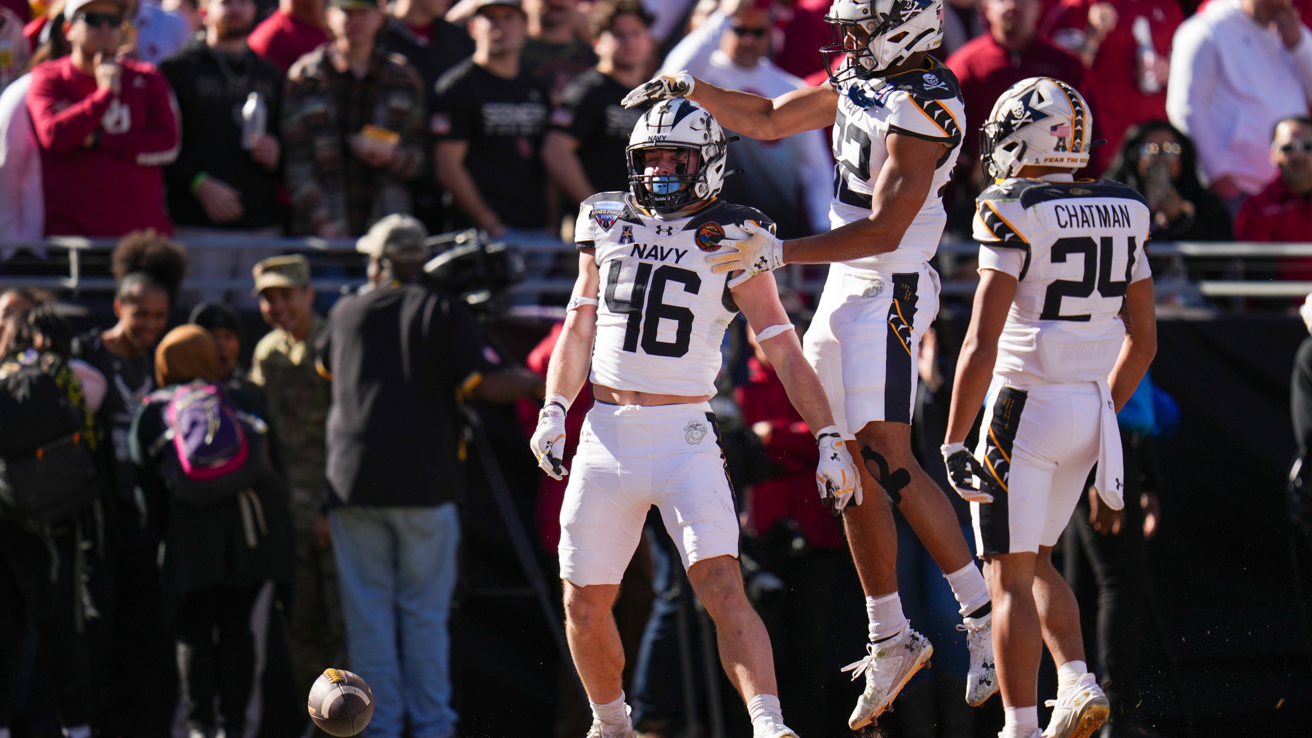 Navy fullback Alex Tecza, (46) celebrates his touchdown run with running backs Eli Heidenreich (22) and Brandon Chatman (24) during the first half of the Armed Forces Bowl NCAA college football game against Oklahoma, Friday, Dec. 27, 2024, in Fort Worth, Texas. (AP Photo/Julio Cortez)