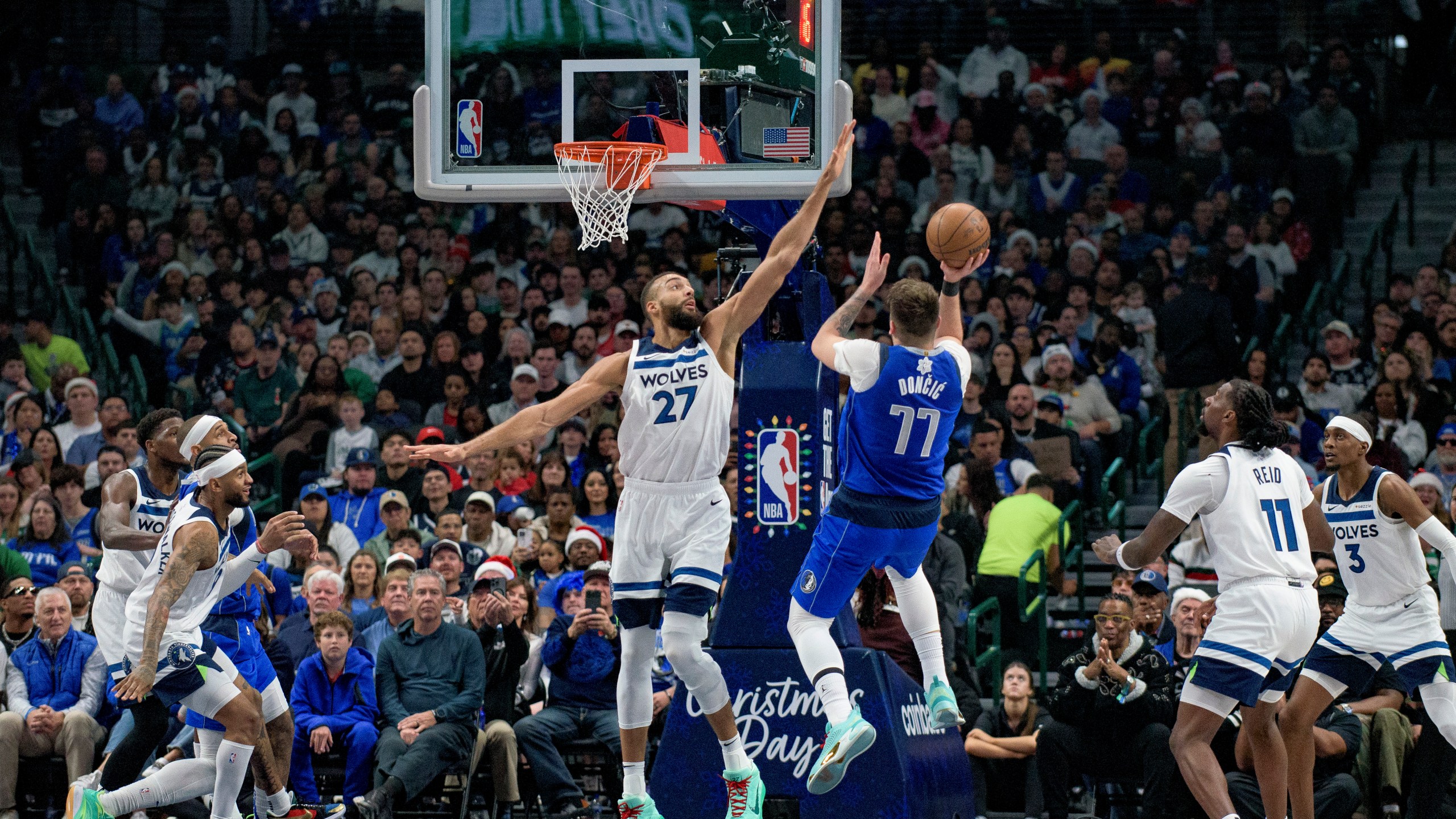 Dallas Mavericks guard Luka Doncic (77) attempts a shot over Minnesota Timberwolves center Rudy Gobert (27) in the first half of an NBA basketball game on Wednesday, Dec. 25, 2024, in Dallas. (AP Photo/Emil T. Lippe)