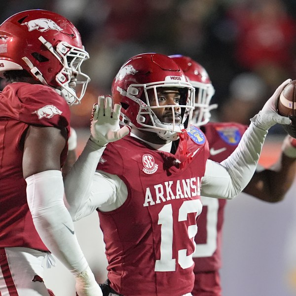 Arkansas defensive back Marquise Robinson (13) celebrates his interception during the second half of the Liberty Bowl NCAA college football game against Texas Tech, Friday, Dec. 27, 2024, in Memphis, Tenn. (AP Photo/George Walker IV)