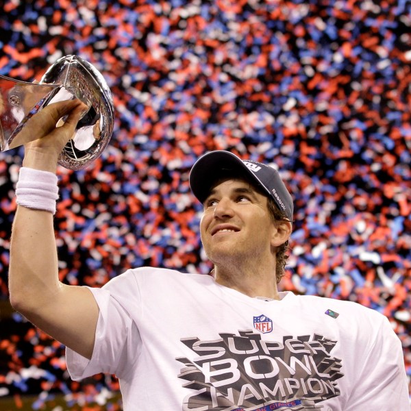 FILE - New York Giants quarterback Eli Manning holds up the Vince Lombardi Trophy while celebrating his team's 21-17 win over the New England Patriots in the NFL Super Bowl XLVI football game, Feb. 5, 2012, in Indianapolis. (AP Photo/David J. Phillip, File)