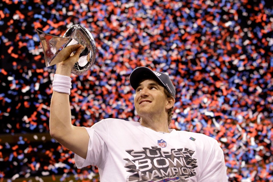 FILE - New York Giants quarterback Eli Manning holds up the Vince Lombardi Trophy while celebrating his team's 21-17 win over the New England Patriots in the NFL Super Bowl XLVI football game, Feb. 5, 2012, in Indianapolis. (AP Photo/David J. Phillip, File)