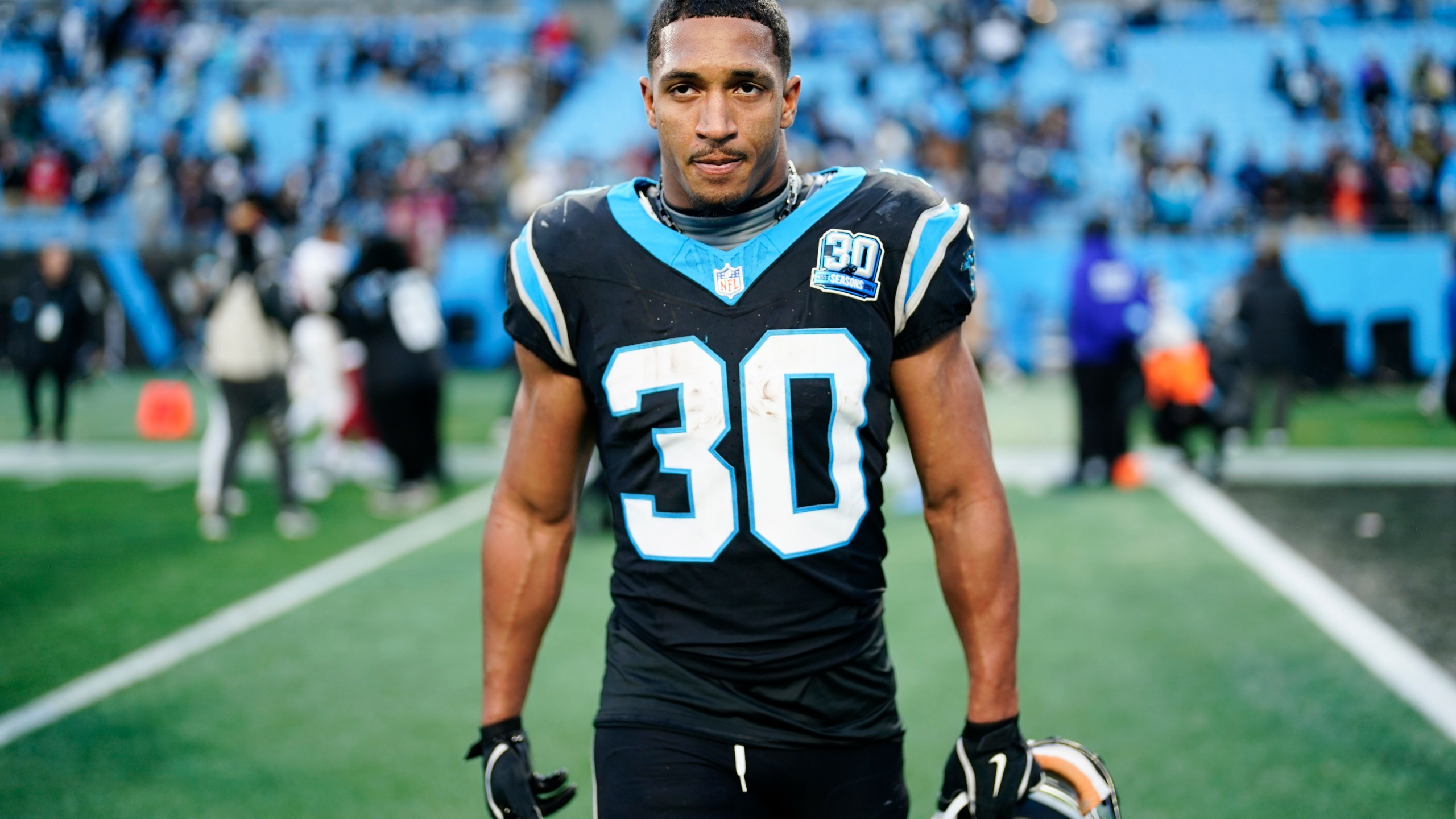 Carolina Panthers running back Chuba Hubbard leaves the field after scoring the winning touchdown against the Arizona Cardinals during overtime of an NFL football game, Sunday, Dec. 22, 2024, in Charlotte, N.C. (AP Photo/Jacob Kupferman)