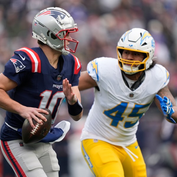 New England Patriots quarterback Drake Maye (10) looks to pass while chased by Los Angeles Chargers linebacker Tuli Tuipulotu (45) during the first half of an NFL football game, Saturday, Dec. 28, 2024, in Foxborough, Mass. (AP Photo/Robert F. Bukaty)