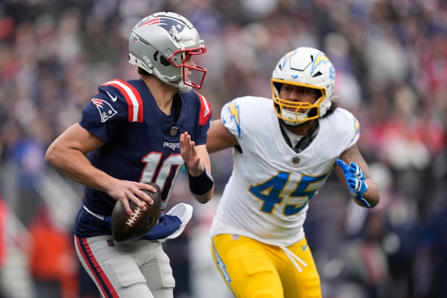 New England Patriots quarterback Drake Maye (10) looks to pass while chased by Los Angeles Chargers linebacker Tuli Tuipulotu (45) during the first half of an NFL football game, Saturday, Dec. 28, 2024, in Foxborough, Mass. (AP Photo/Robert F. Bukaty)