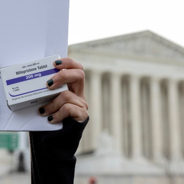 FILE - An abortion- rights activist holds a box of mifepristone pills as demonstrators from both anti-abortion and abortion-rights groups rally outside the Supreme Court in Washington, Tuesday, March 26, 2024. (AP Photo/Amanda Andrade-Rhoades, File)