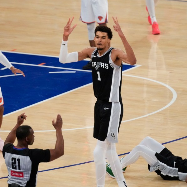 San Antonio Spurs' Victor Wembanyama (1), center, reacts as he sinks a three point basket during the second half of an NBA basketball game against the New York Knicks, Wednesday, Dec. 25, 2024, in New York. The basket was not counted after an officials review. The Knicks defeated the Spurs 117-114. (AP Photo/Seth Wenig)