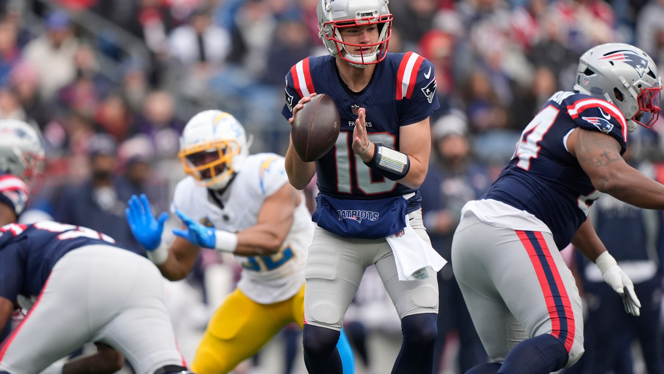 New England Patriots quarterback Drake Maye (10) looks to pass against the Los Angeles Chargers during the first half of an NFL football game, Saturday, Dec. 28, 2024, in Foxborough, Mass. (AP Photo/Robert F. Bukaty)