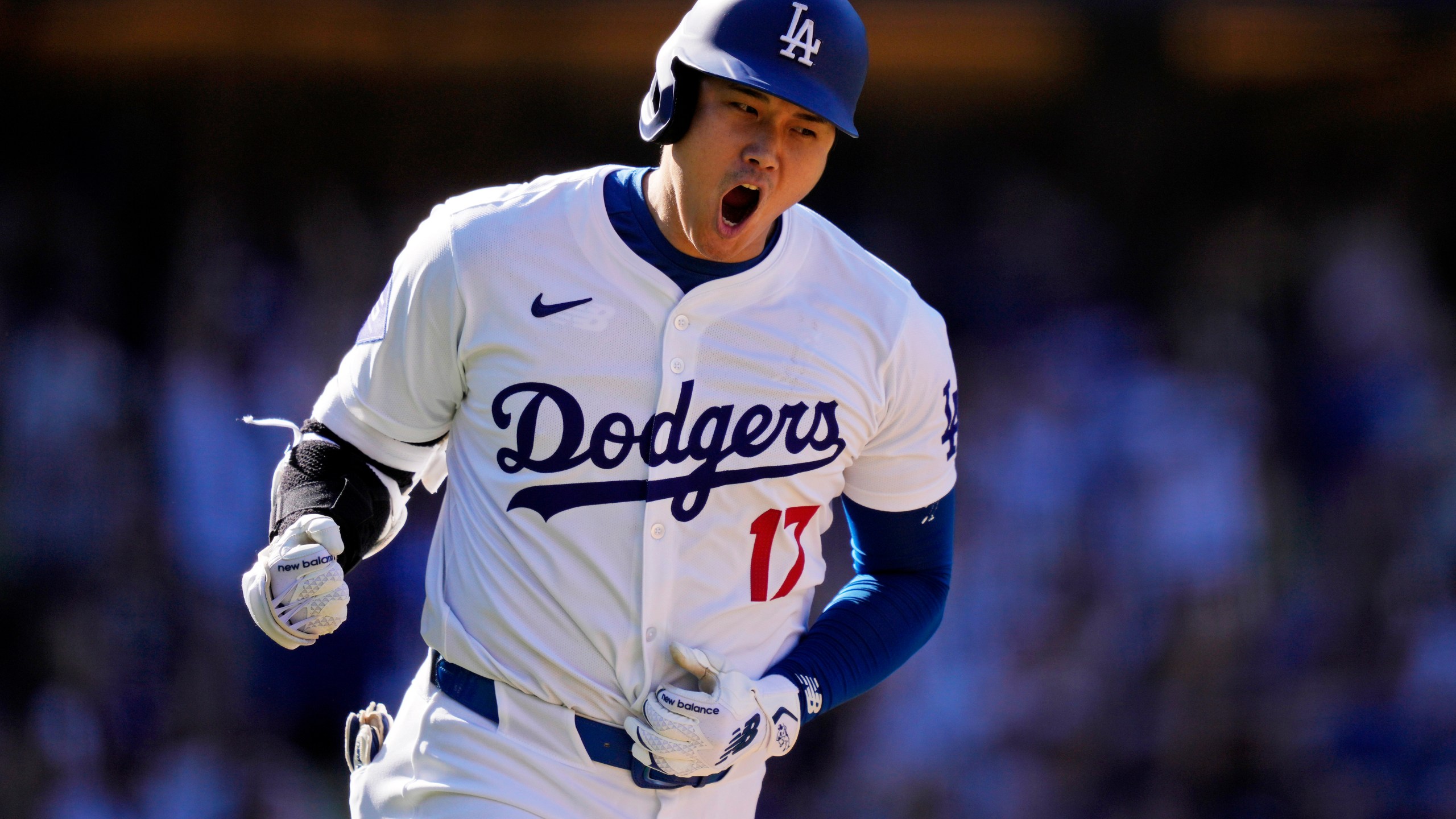 FILE - Los Angeles Dodgers' Shohei Ohtani celebrates as he heads to first for a solo home run during the ninth inning of a baseball game against the Colorado Rockies, Sunday, Sept. 22, 2024, in Los Angeles. (AP Photo/Mark J. Terrill, File)