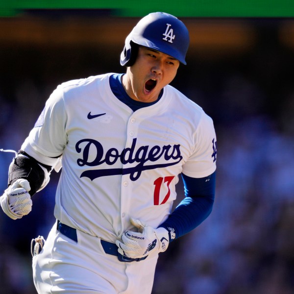 FILE - Los Angeles Dodgers' Shohei Ohtani celebrates as he heads to first for a solo home run during the ninth inning of a baseball game against the Colorado Rockies, Sunday, Sept. 22, 2024, in Los Angeles. (AP Photo/Mark J. Terrill, File)