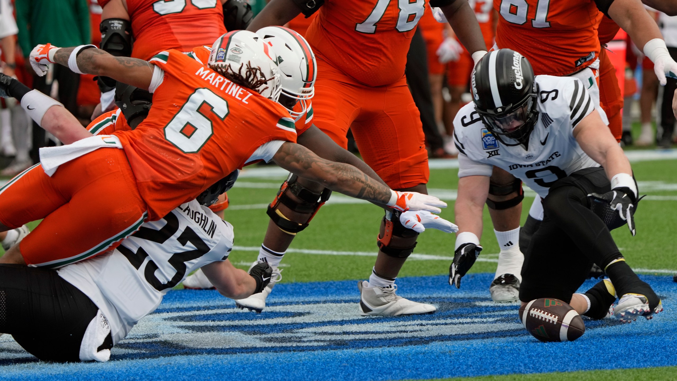 Iowa State linebacker Cael Brezina (9) recovers a Miami fumble in front of running back Damien Martinez (6) during the first half of the Pop Tarts Bowl NCAA college football game, Saturday, Dec. 28, 2024, in Orlando, Fla. (AP Photo/John Raoux)