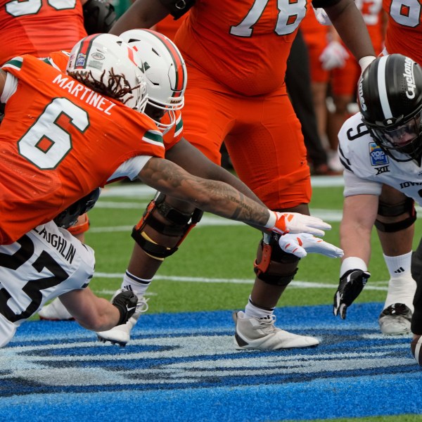 Iowa State linebacker Cael Brezina (9) recovers a Miami fumble in front of running back Damien Martinez (6) during the first half of the Pop Tarts Bowl NCAA college football game, Saturday, Dec. 28, 2024, in Orlando, Fla. (AP Photo/John Raoux)