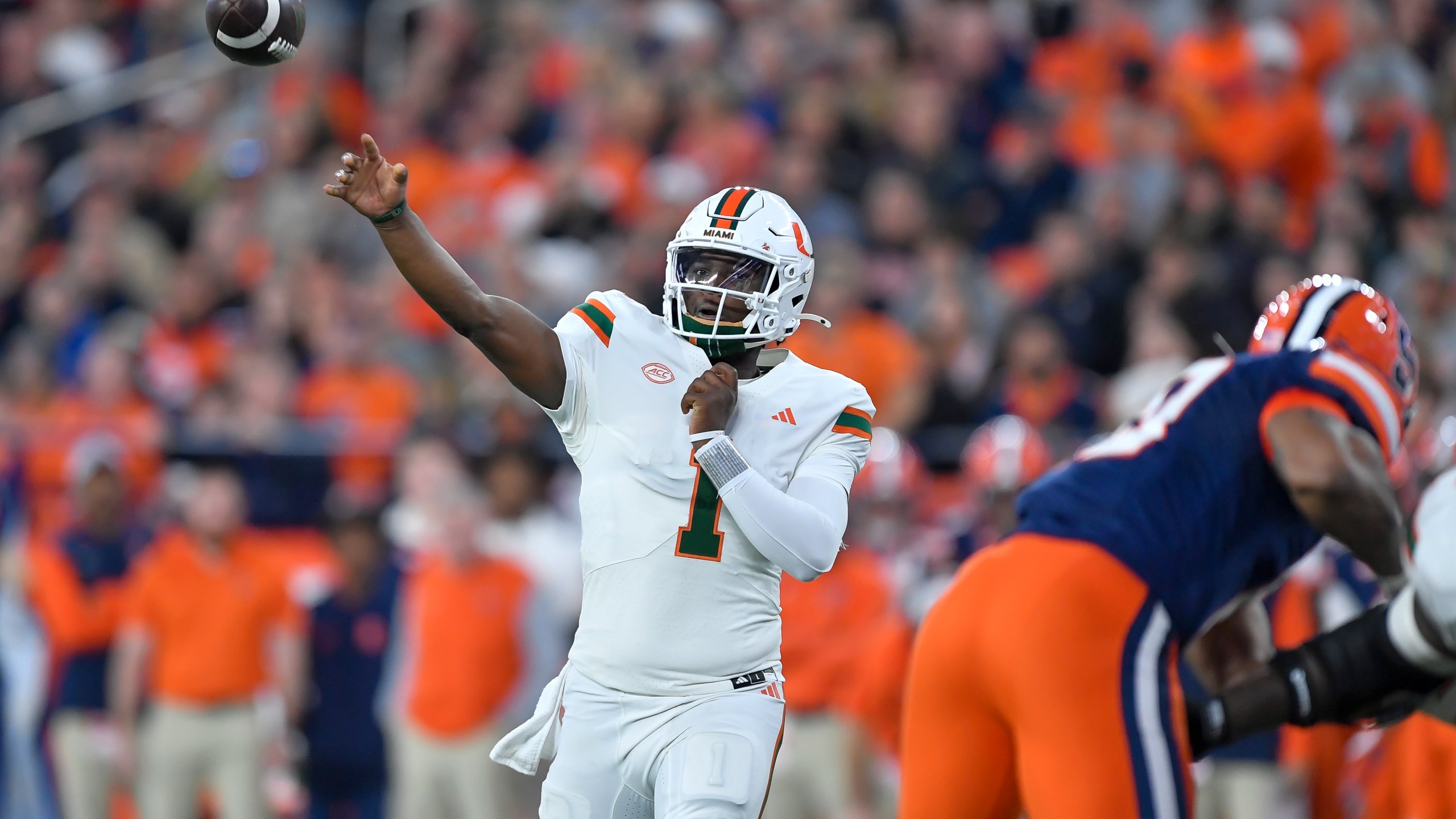 Miami quarterback Cam Ward (1) throws during the first half of an NCAA college football game against Syracuse on Saturday, Nov. 30, 2024 in Syracuse, N.Y. (AP Photo/Adrian Kraus)