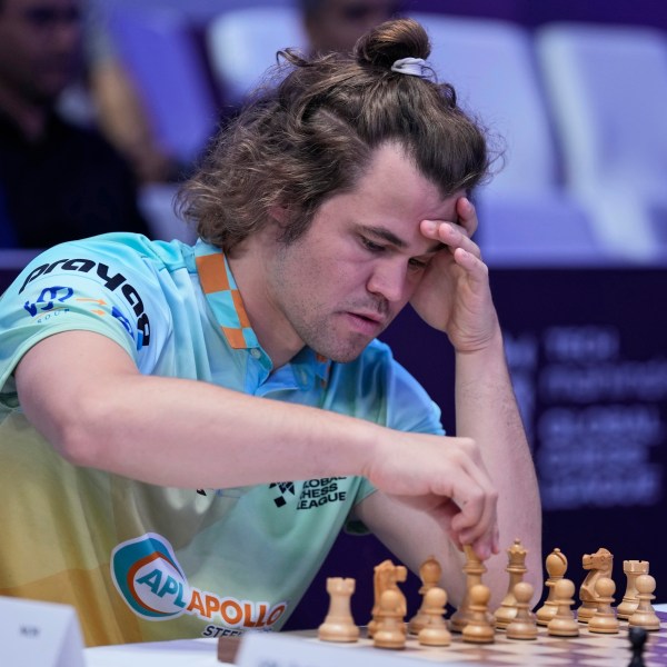 FILE - Norwegian Magnus Carlsen of SG Alpine Warriors plays against Poland's Jan-Krzysztof Duda of Chingari Gulf Titans during Global Chess League, July 1, 2023, in Dubai. (AP Photo/Kamran Jebreili, File)