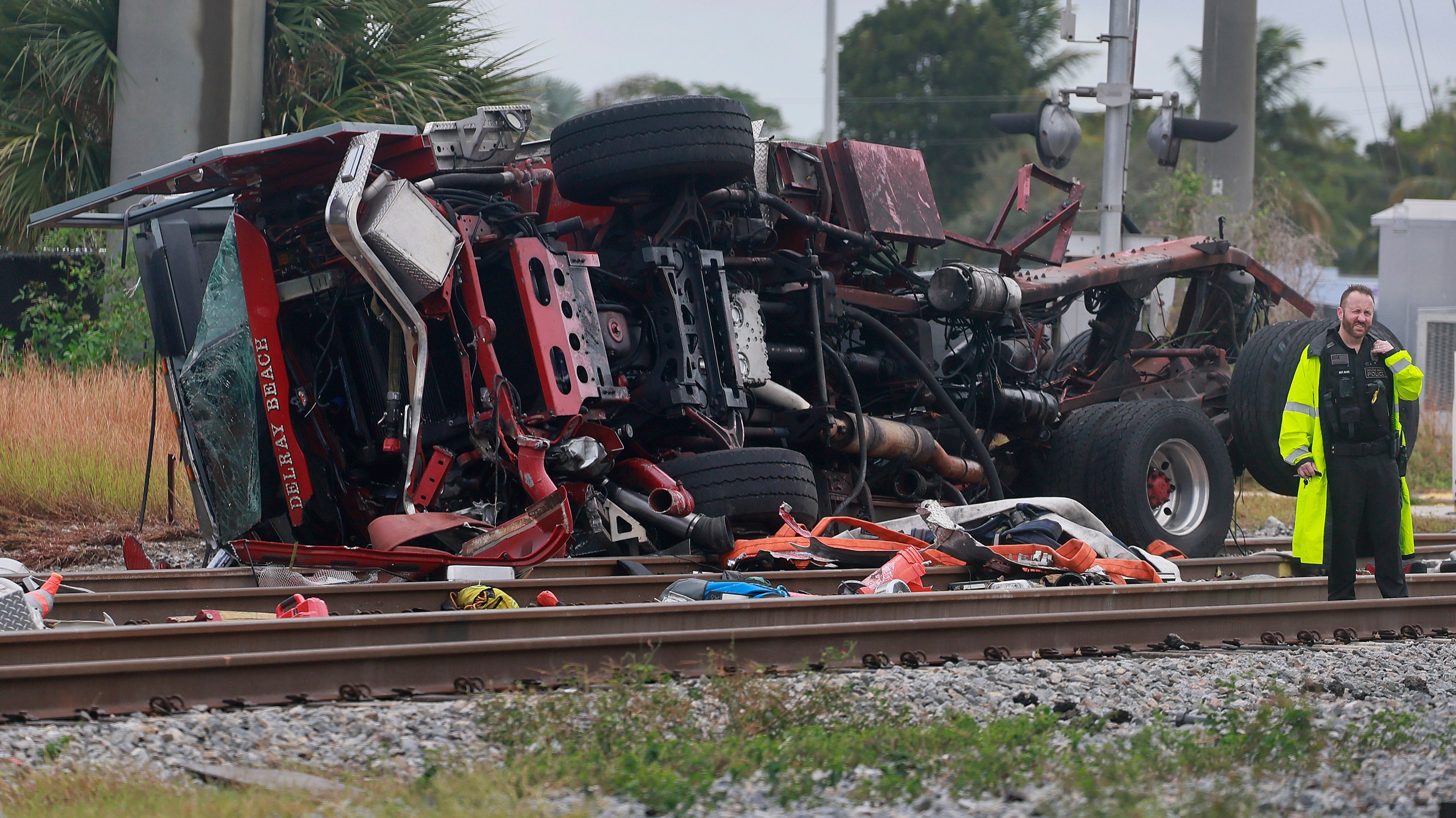 A damaged fire truck is on its side after colliding with a train in downtown Delray Beach, Fla., Saturday, Dec. 28, 2024. (Mike Stocker/South Florida Sun-Sentinel via AP)