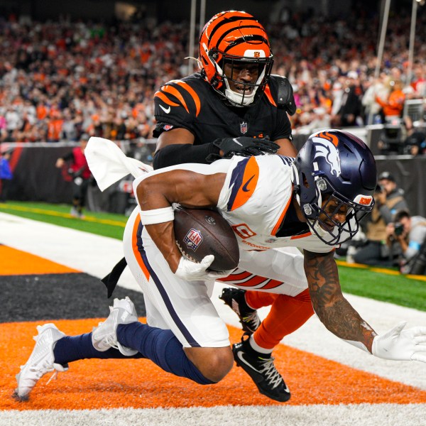 Denver Broncos wide receiver Courtland Sutton (14) makes a catch for a touchdown in front of Cincinnati Bengals cornerback Josh Newton (28) during the second half of an NFL football game in Cincinnati, Saturday, Dec. 28, 2024. (AP Photo/Jeff Dean)