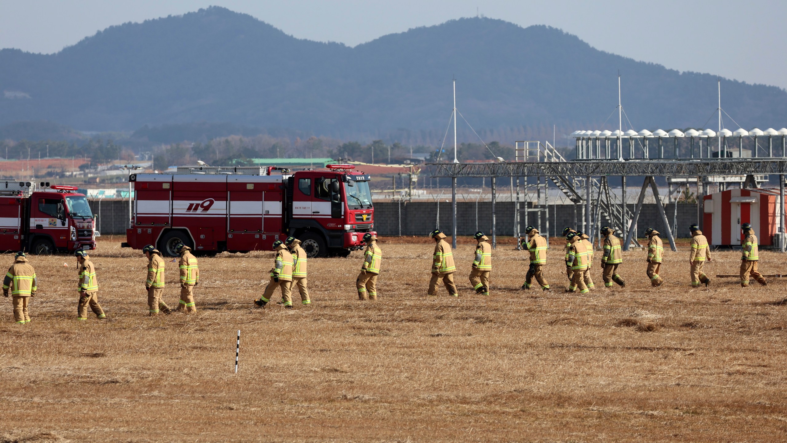 Firefighters and rescue team members work at Muan International Airport in Muan, South Korea, Sunday, Dec. 29, 2024. (Cho Nam-soo/Yonhap via AP)