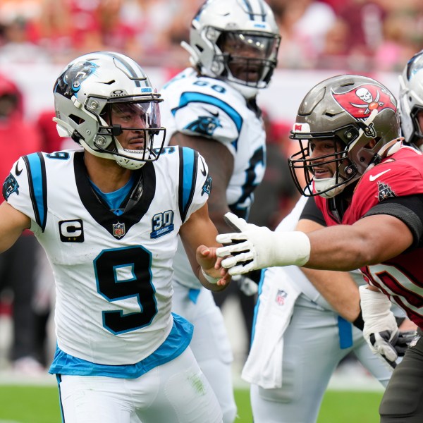 Carolina Panthers quarterback Bryce Young passes under pressure from Tampa Bay Buccaneers defensive end Logan Hall during the first half of an NFL football game Sunday, Dec. 29, 2024, in Tampa, Fla. (AP Photo/Chris O'Meara)