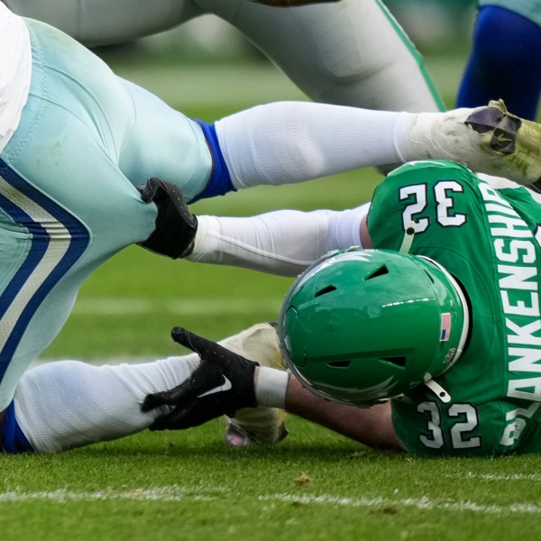 Philadelphia Eagles safety Reed Blankenship, right, grabs at Dallas Cowboys running back Rico Dowdle while tackling him during the second half of an NFL football game, Sunday, Dec. 29, 2024, in Philadelphia. (AP Photo/Matt Slocum)