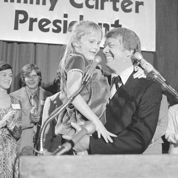 FILE - Georgia Gov. Jimmy Carter holds his daughter, Amy, just after he made his official announcement that he would seek the Democratic nomination for presidency on Dec. 13, 1974, in Atlanta. (AP Photo, File)