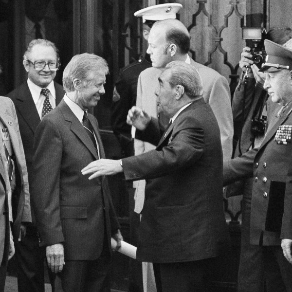 FILE - President Jimmy Carter, left center, smiles as Soviet President and Party Chief Leonid Brezhnev, center, jokes around him outside the U.S. Embassy in Vienna, Austria, June 16, 1979, before they head for their second round of talks prior to the signing of the SALT II Treaty. (AP Photo, File)