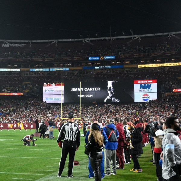 A video tribute to former President Jimmy Carter is seen before an NFL football game between the Washington Commanders and the Atlanta Falcons, Sunday, Dec. 29, 2024, in Landover. (AP Photo/Nick Wass)