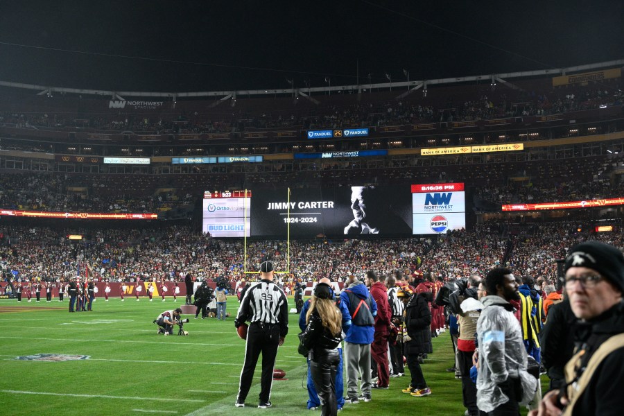 A video tribute to former President Jimmy Carter is seen before an NFL football game between the Washington Commanders and the Atlanta Falcons, Sunday, Dec. 29, 2024, in Landover. (AP Photo/Nick Wass)