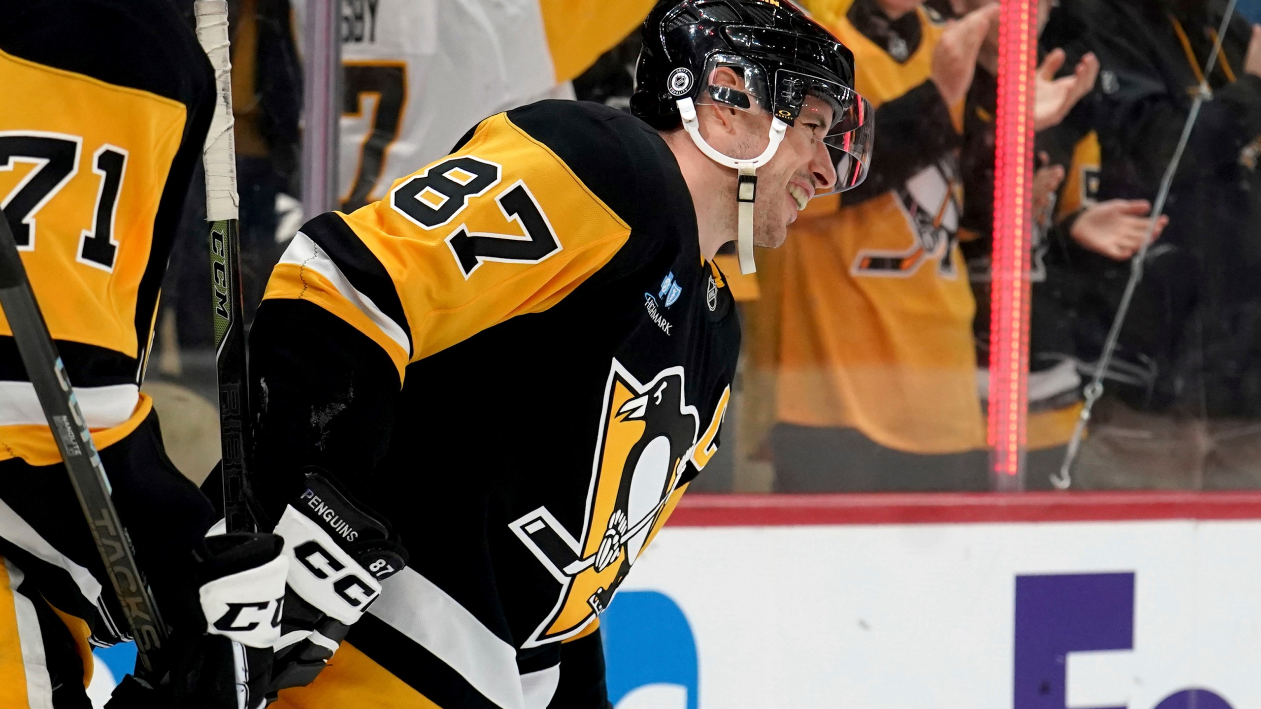 Pittsburgh Penguins' Sidney Crosby (87) celebrates after surpassing Mario Lemieux for the team's all-time leader in assists on a goal by Michael Bunting during the second period of an NHL hockey game against the New York Islanders, Sunday, Dec. 29, 2024, in Pittsburgh. (AP Photo/Matt Freed)