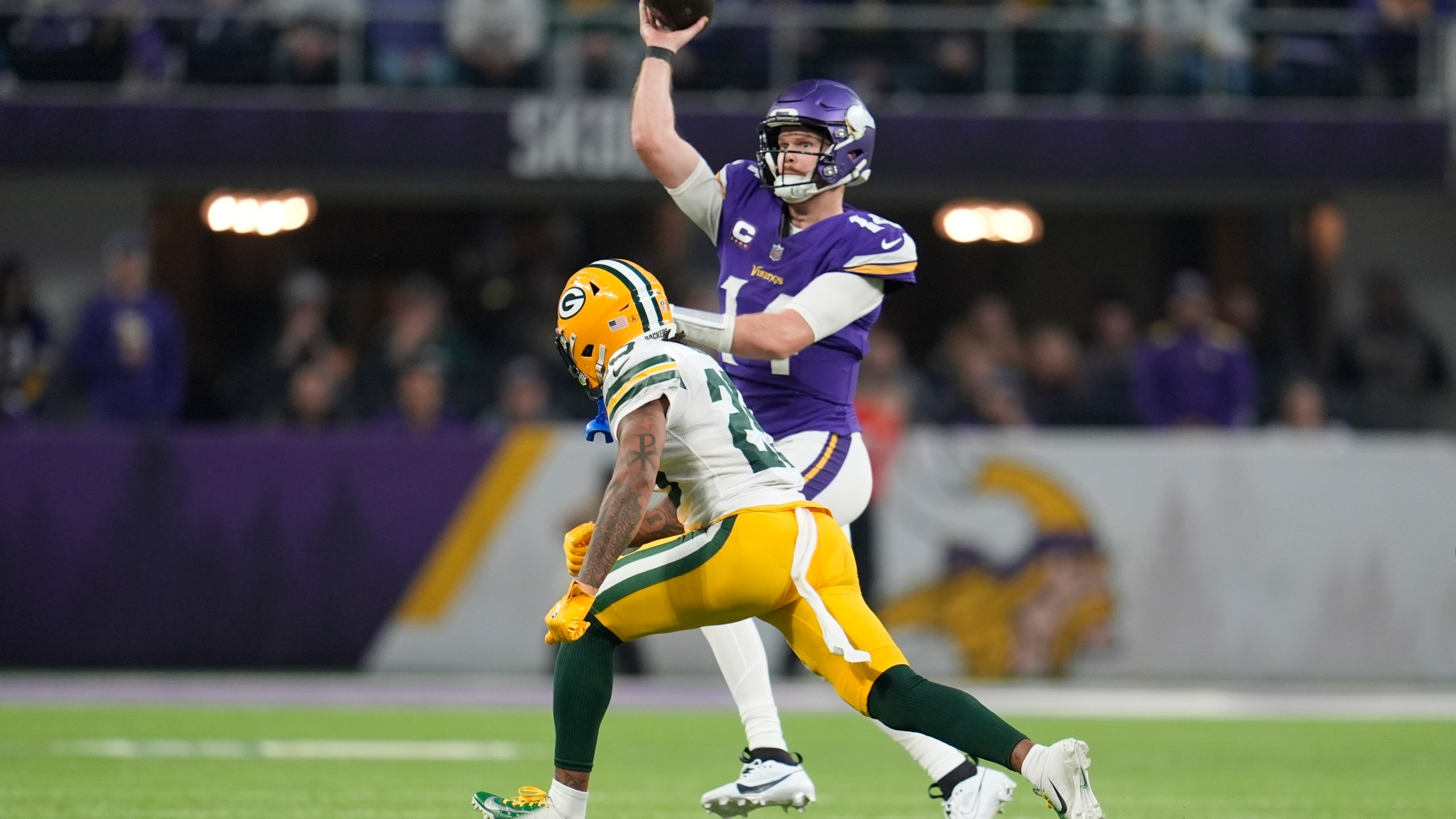 Minnesota Vikings' Sam Darnold throws while being pressured by Green Bay Packers' Keisean Nixon during the first half of an NFL football game Sunday, Dec. 29, 2024, in Minneapolis. (AP Photo/Abbie Parr)