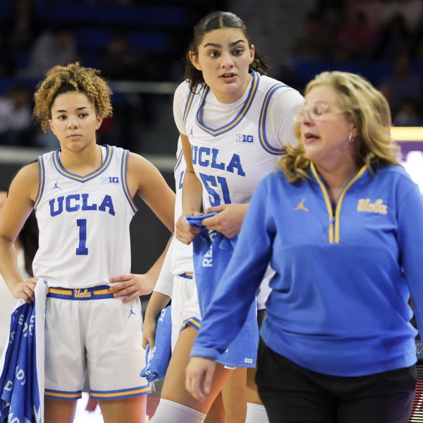 UCLA guard Kiki Rice, left, and center Lauren Betts, center, speak with head coach Cori Close during the second half of an NCAA college basketball game against Nebraska Sunday, Dec. 29, 2024, in Los Angeles. (AP Photo/Ryan Sun)